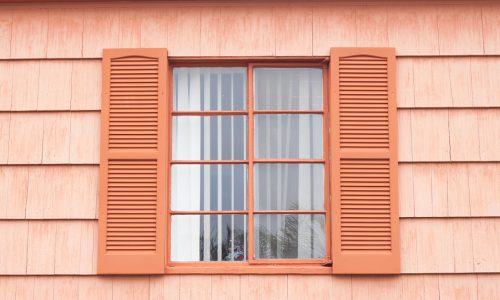 Vintage window with orange tone wall